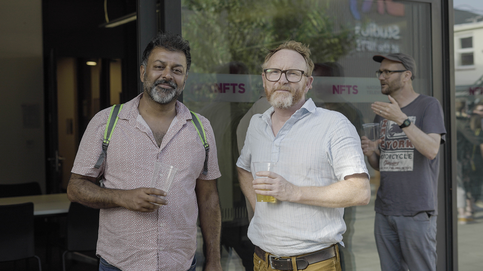 Two alumni stood outside buildling