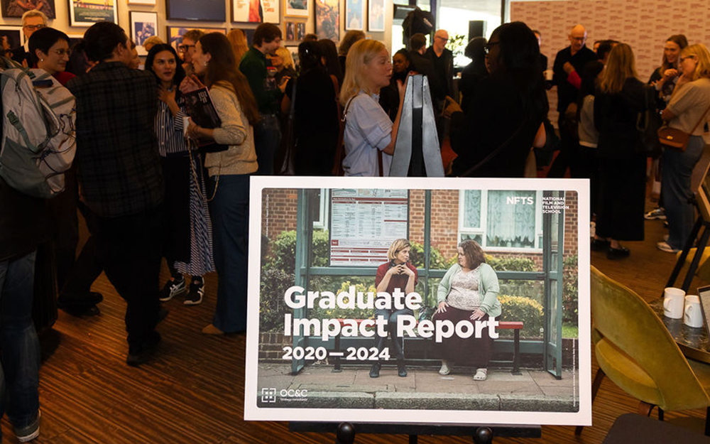 Graduate Impact Report poster with people behind it chatting