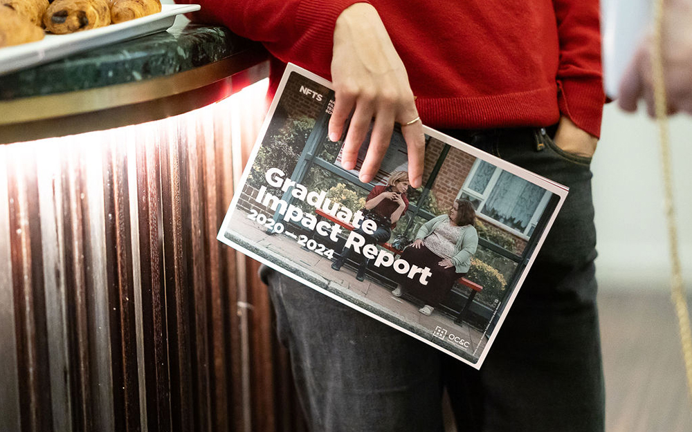 Person holding report brochure