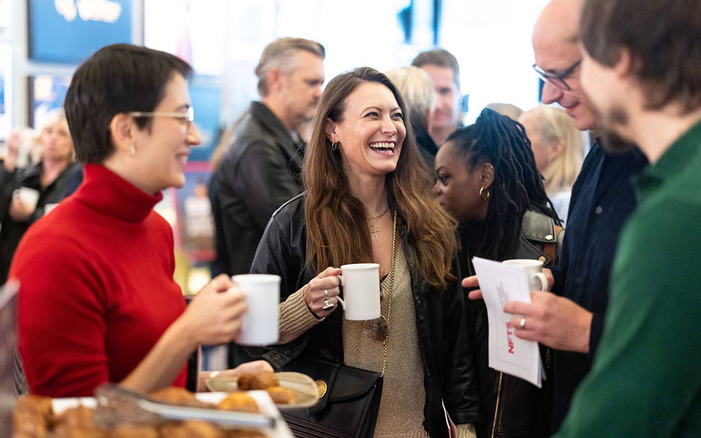 People chatting and laughing at launch event