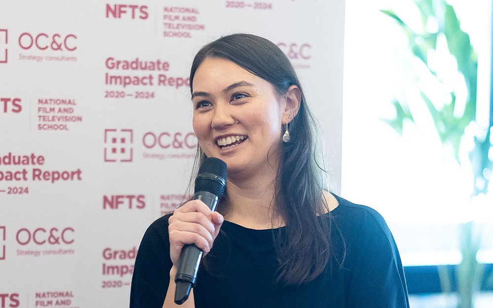 Woman industry member talking into microphone