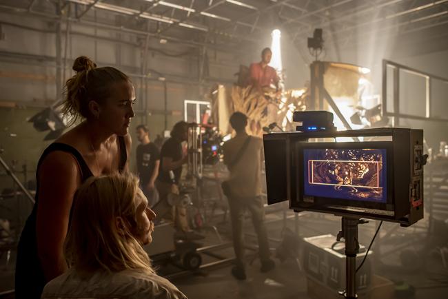 students looking at monitor on film set